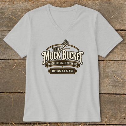 Light grey t-shirt with a logo that reads "The Muck Bucket School of Stall Cleaning Opens at 5 AM".