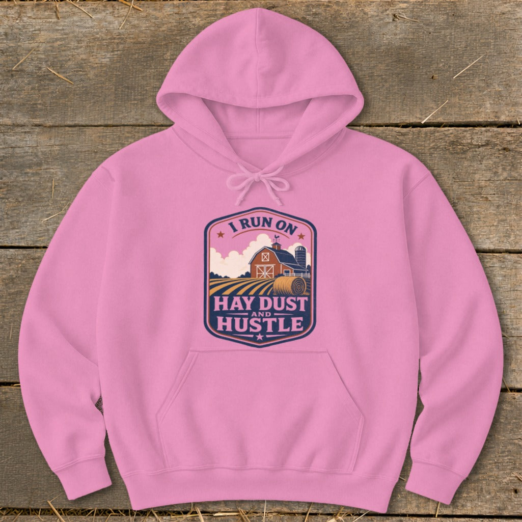 Pink hoodie with "I Run On Hay Dust And Hustle" farm graphic.