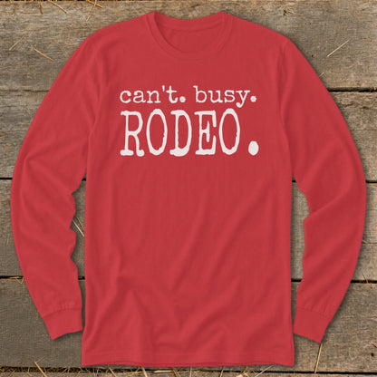 Red long sleeve shirt with white text that reads "can't. busy. RODEO."