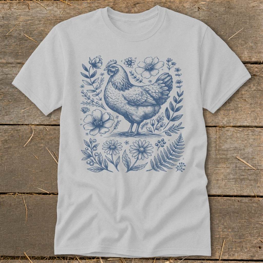 Light gray t-shirt with a blue line drawing of a chicken surrounded by flowers.