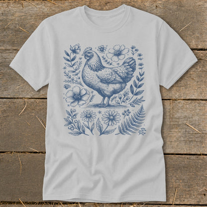 Light gray t-shirt with a blue line drawing of a chicken surrounded by flowers.