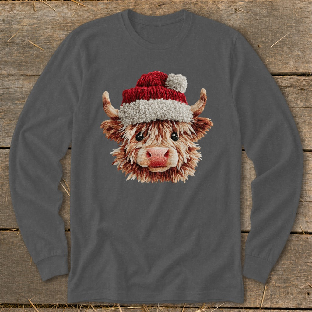 Long sleeve shirt with a Christmas highland cow graphic wearing a Santa hat.