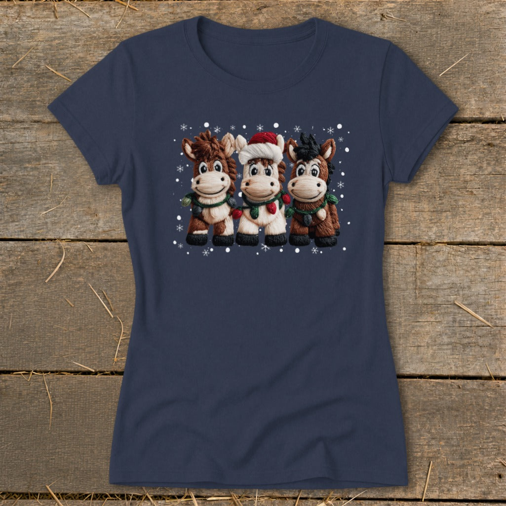 Three cartoon horses wearing scarves and one wearing a Santa hat, with snowflakes.