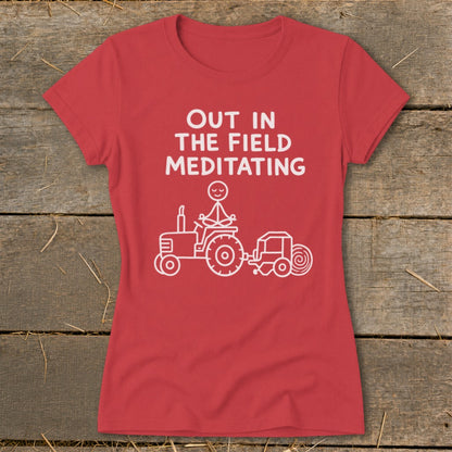 Red t-shirt with "Out in the field meditating" and a stick figure meditating on a tractor.