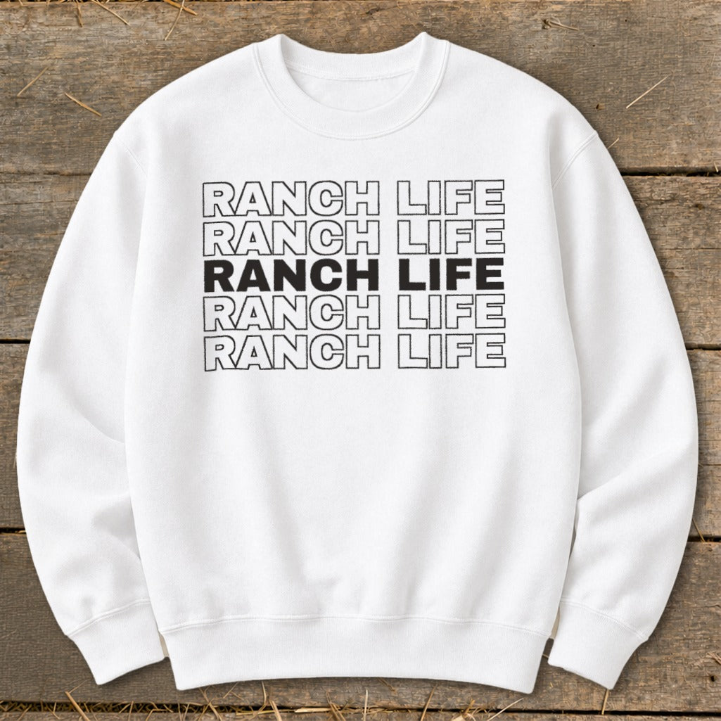 A white crewneck sweatshirt featuring five stacked lines of text reading RANCH LIFE.
