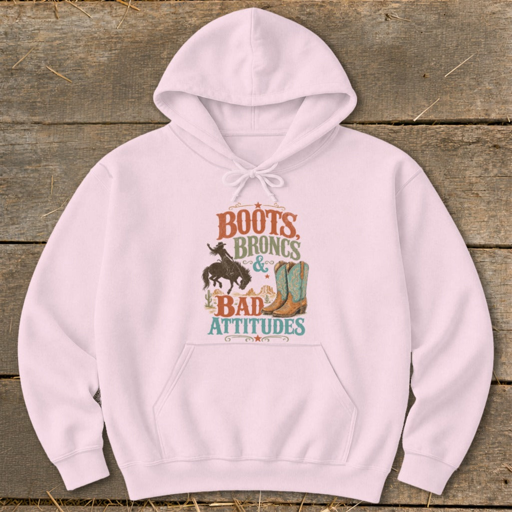 Pink hoodie with "Boots Broncs & Bad Attitudes" graphic including cowboy and boots.