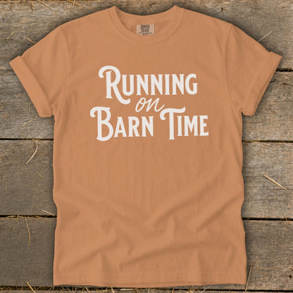 Orange t-shirt with white text "Running on Barn Time"
