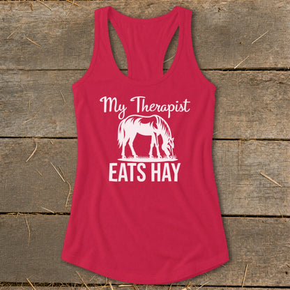 Red tank top with white text "My Therapist EATS HAY" and a horse silhouette.