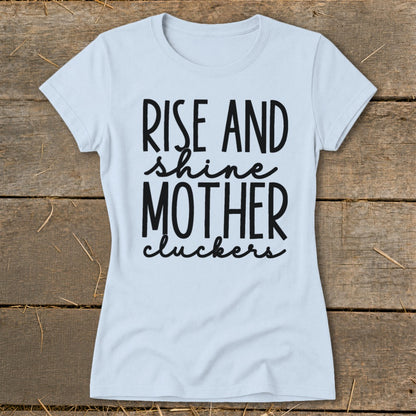 Light blue t-shirt with black text that reads "RISE AND shine MOTHER cluckers".