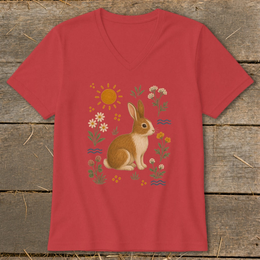Red v-neck t-shirt with a whimsical illustration of a rabbit among flowers and the sun.