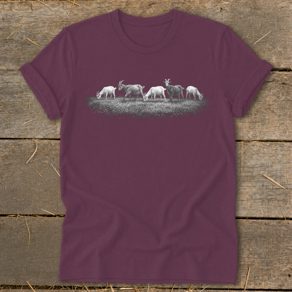Five goats graze in a grassy field with a textured background.