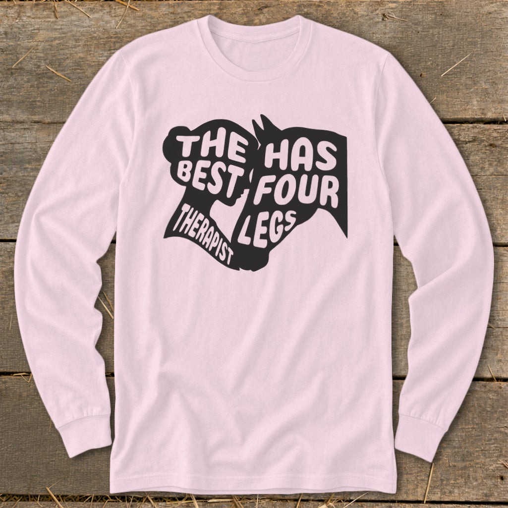 Pink long-sleeve shirt with black text: "The best therapist has four legs."