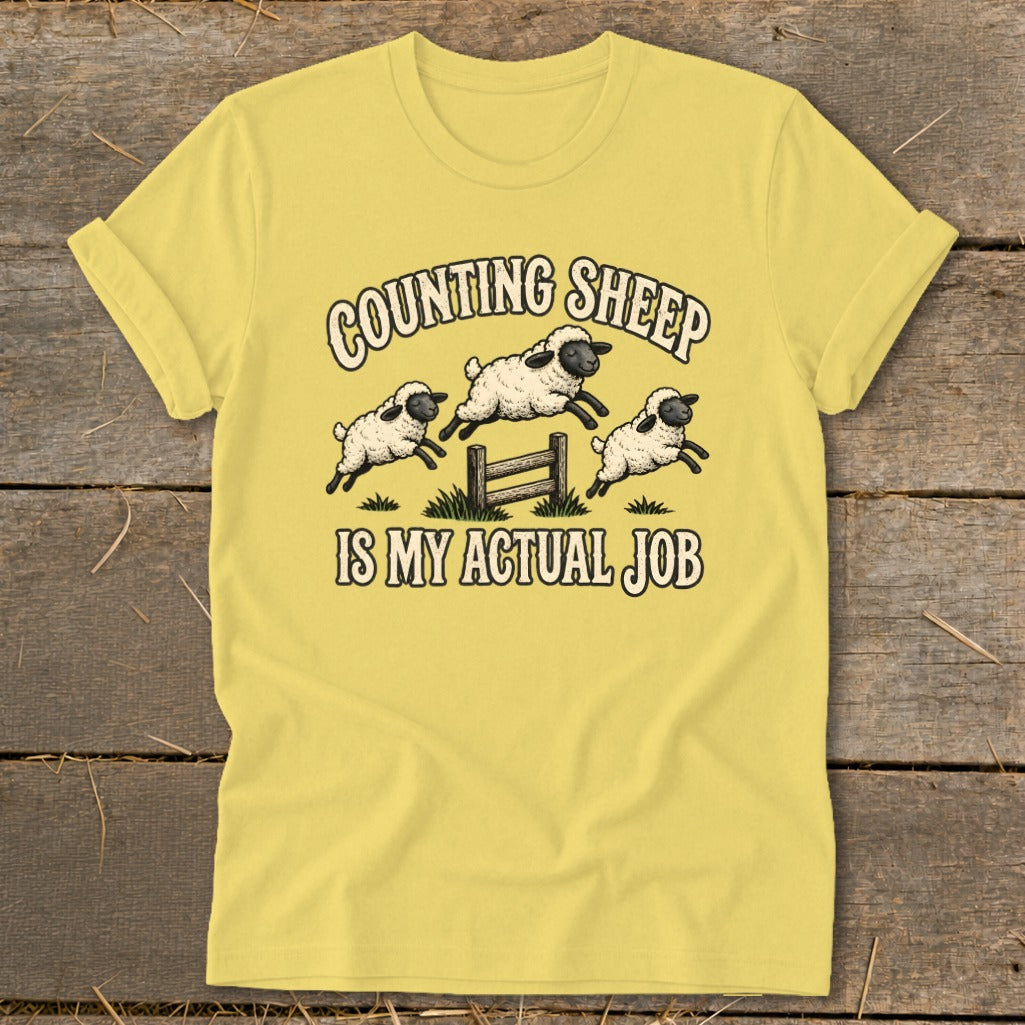 Yellow t-shirt with "Counting Sheep Is My Actual Job" text and jumping sheep graphic.