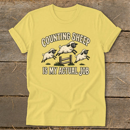 Yellow t-shirt with "Counting Sheep Is My Actual Job" text and jumping sheep graphic.
