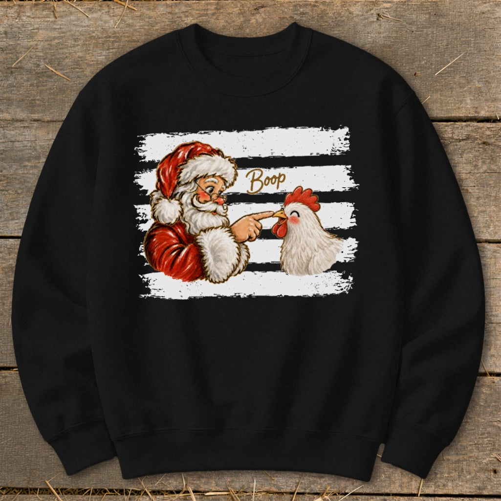 Santa Claus booping a chicken's nose with the word "Boop" written above.