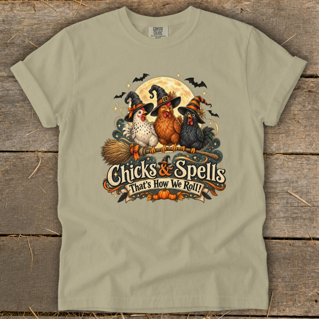 Three chickens in witch hats on a broomstick with text "Chicks & Spells".
