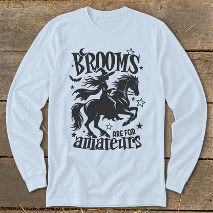 Black graphic of a witch on a horse with text that says "Brooms are for amateurs."
