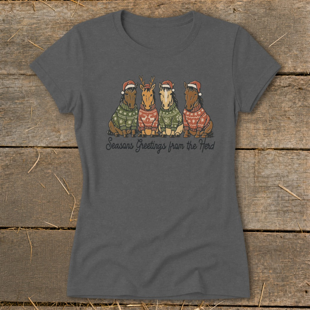 Four horses wearing Christmas sweaters and Santa hats with text "Seasons Greetings from the Herd."