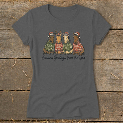 Four horses wearing Christmas sweaters and Santa hats with text "Seasons Greetings from the Herd."