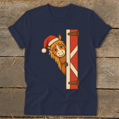 Navy t-shirt with a cartoon horse wearing a Santa hat peeking from behind a barn door.