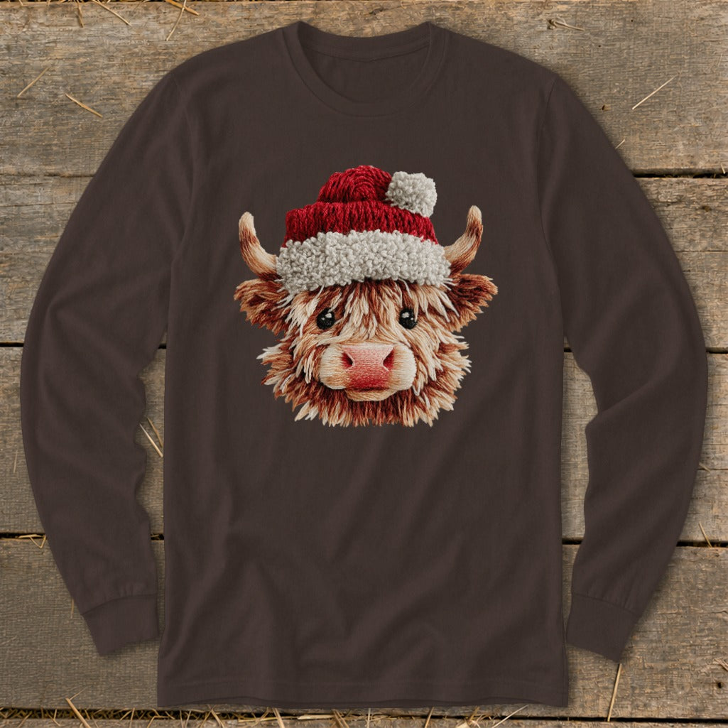 Long sleeve brown shirt with a Highland cow wearing a Santa hat graphic.