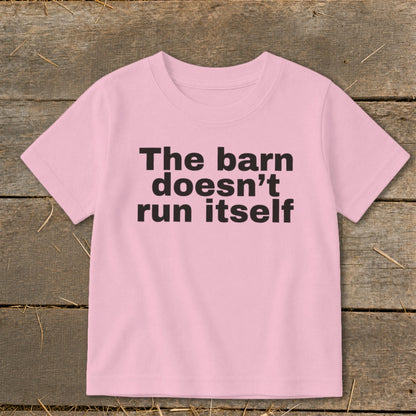 Pink t-shirt with black text reading "The barn doesn't run itself".