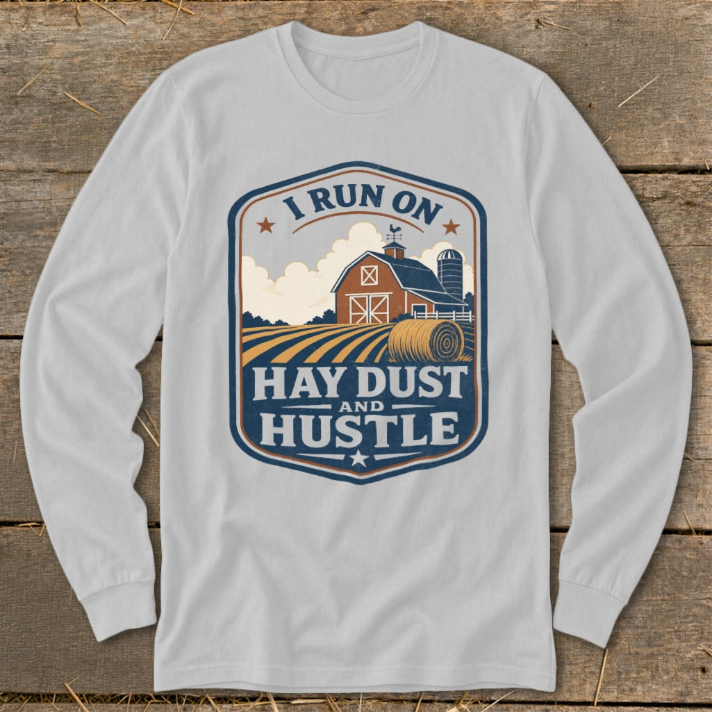 Long sleeve shirt with a farm scene and text "I RUN ON HAY DUST AND HUSTLE".