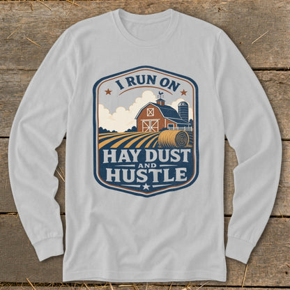 Long sleeve shirt with a farm scene and text "I RUN ON HAY DUST AND HUSTLE".