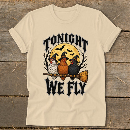 Three chickens wearing witch hats sit on a broomstick, with "Tonight We Fly" text.