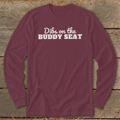 Maroon long-sleeve t-shirt with white text reading "Dibs on the BUDDY SEAT".