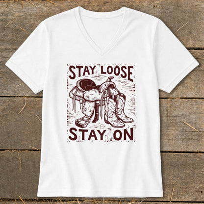 White t-shirt with a saddle and cowboy boots graphic and text "STAY LOOSE STAY ON".