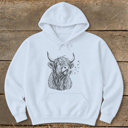 White hoodie featuring a sketch of a Highland cow blowing a dandelion.