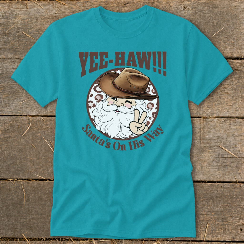 Yee-haw! Santa in cowboy hat, making peace sign, text says Santa's On His Way.