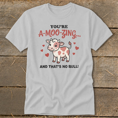 Light grey t-shirt with a cow graphic and text "YOU'RE A-MOO-ZING... AND THAT'S NO BULL!".