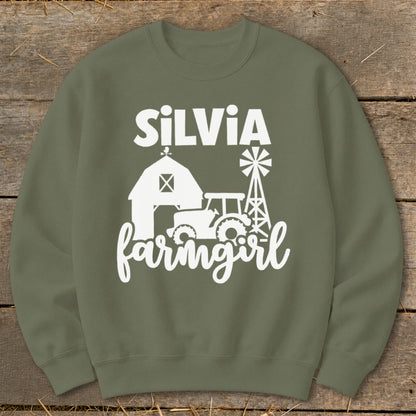 Green sweatshirt with white text and graphics of a barn, tractor, and windmill.