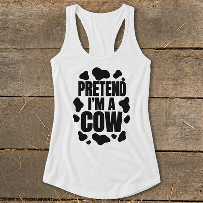 White tank top with black text reading "PRETEND I'M A COW" and cow spots.