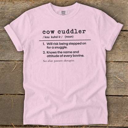 Pink t-shirt with "cow cuddler" definition: risk stepped on for snuggle, knows bovine name.