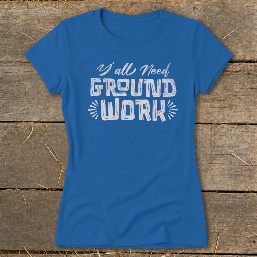 Blue t-shirt with white text reading "Y'all Need GROUND WORK".