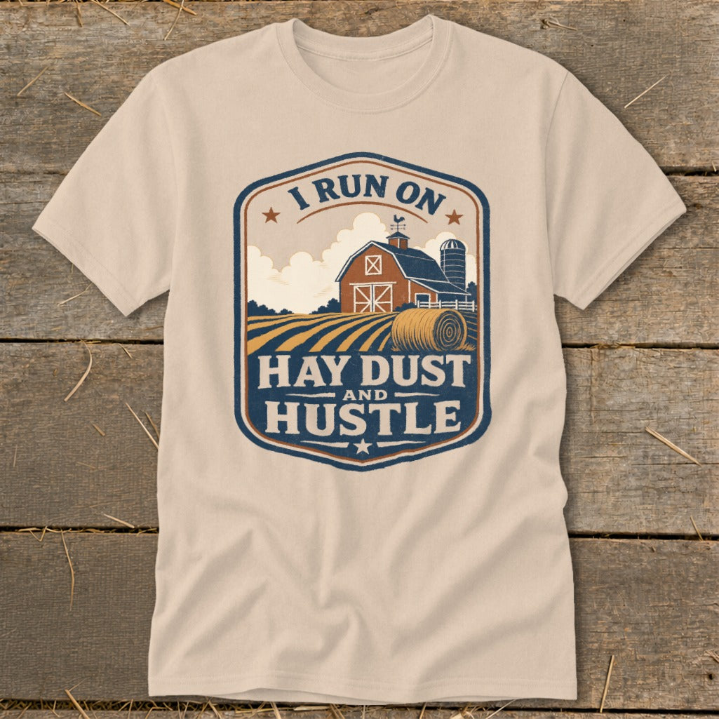 Cream t-shirt with barn, hay bale, and text "I Run On Hay Dust and Hustle".