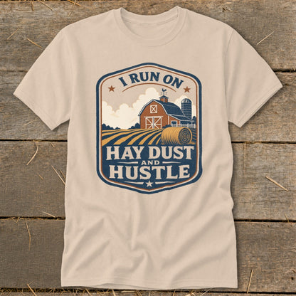 Cream t-shirt with barn, hay bale, and text "I Run On Hay Dust and Hustle".
