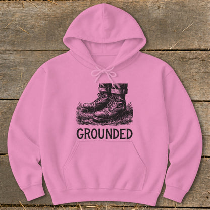 Pink hoodie with black graphic of combat boots and the word "GROUNDED."