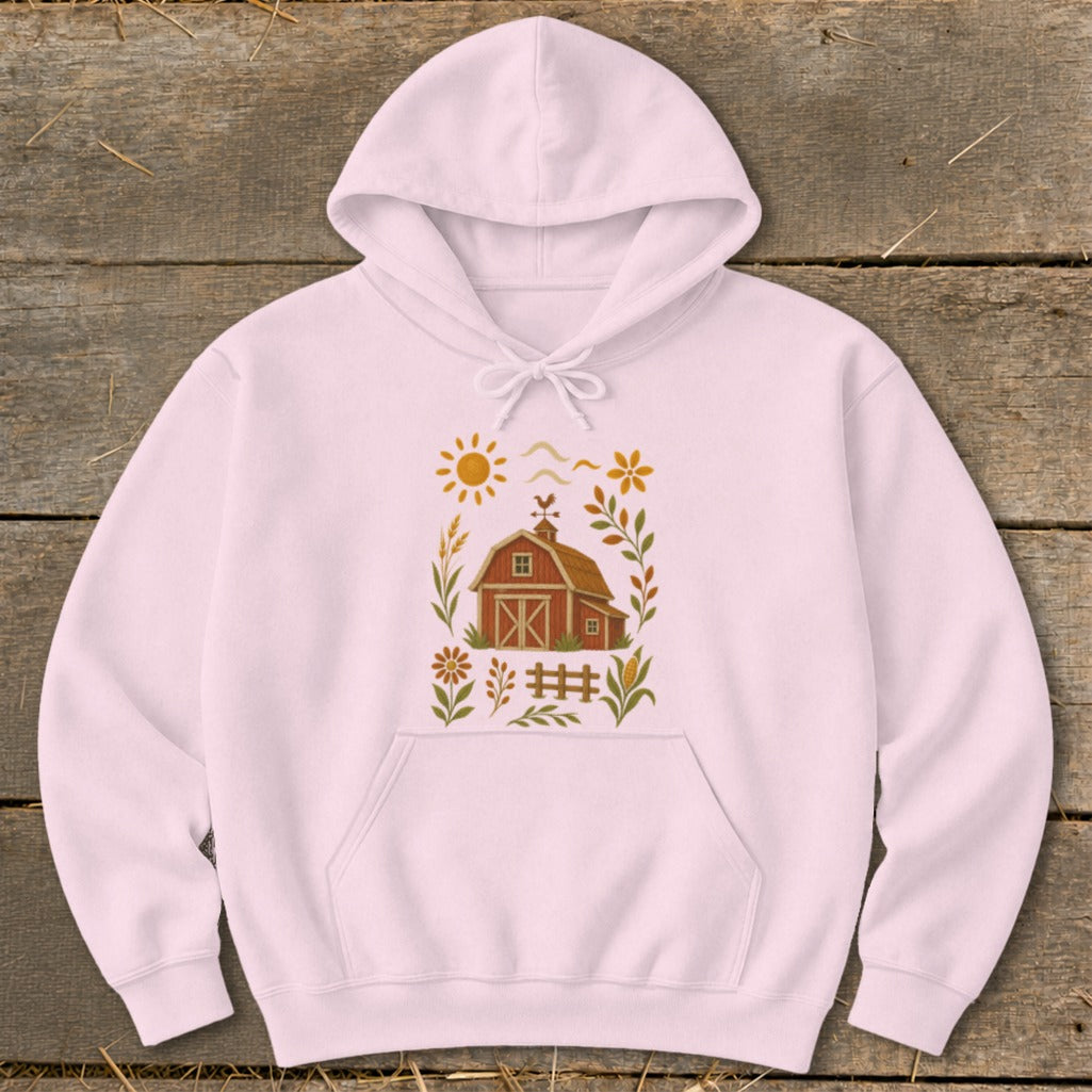 Pink hoodie with a rustic farm scene graphic featuring a barn, sun, and flowers.
