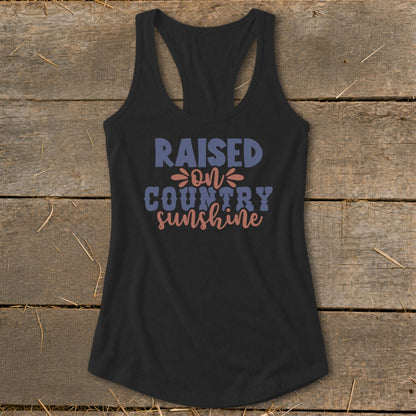 Black tank top with "RAISED ON COUNTRY SUNSHINE" text.