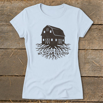 Light blue t-shirt with barn and roots graphic and text "MY ROOTS RUN DEEP".