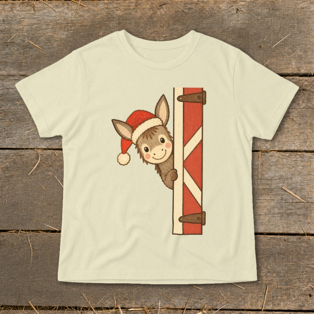 Donkey wearing a Santa hat peeking from behind a barn door graphic on a t-shirt.