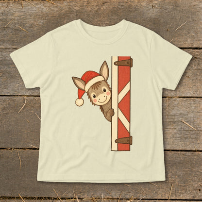 Donkey wearing a Santa hat peeking from behind a barn door graphic on a t-shirt.