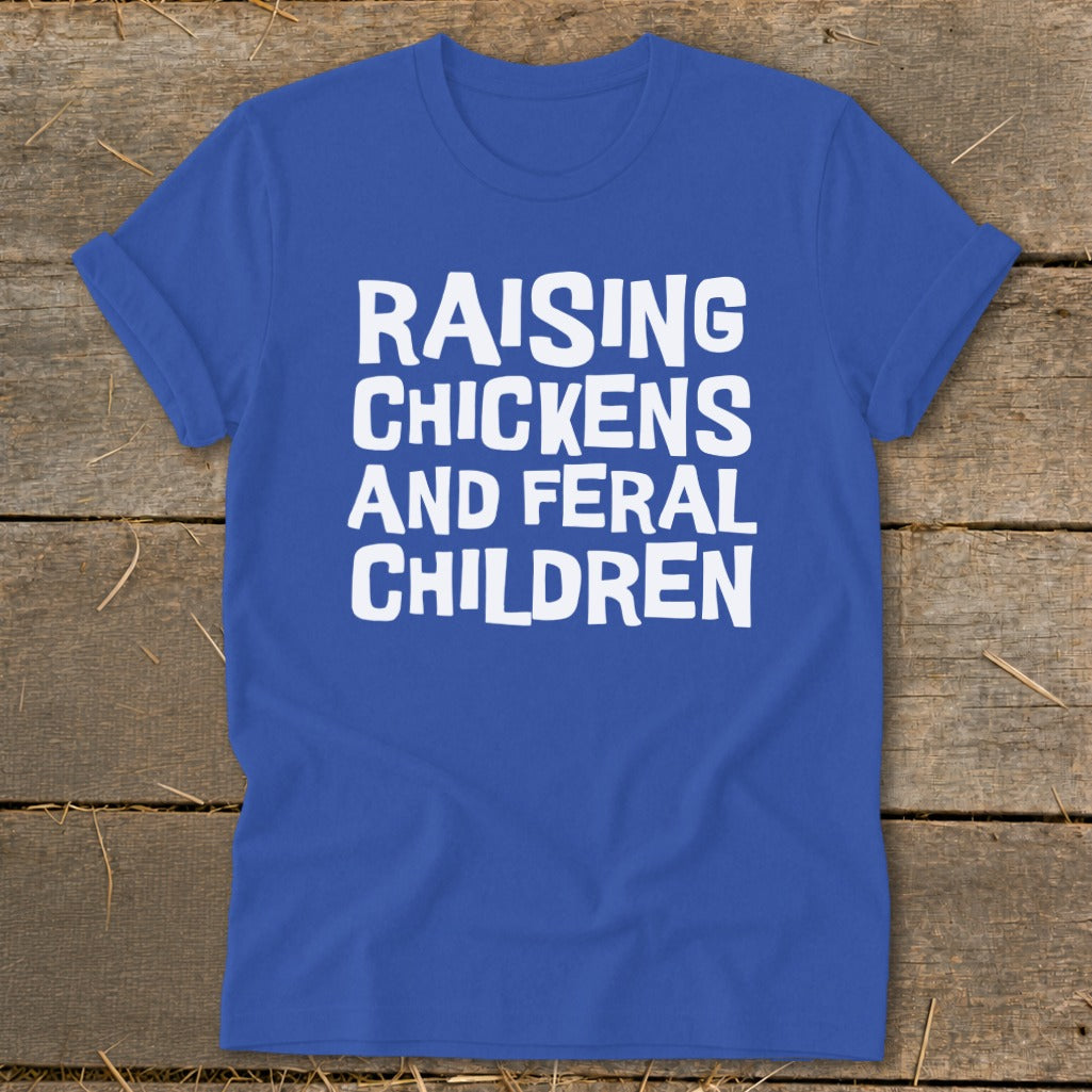 Royal blue t-shirt with white text reading "RAISING CHICKENS AND FERAL CHILDREN".