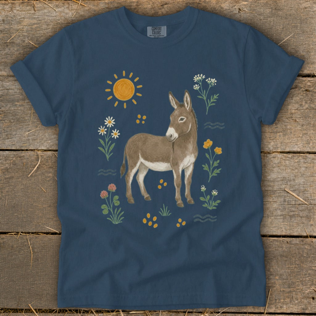Donkey surrounded by flowers, sun, and waves on a navy t-shirt.