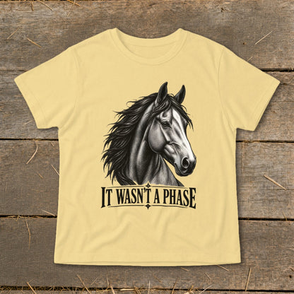 Yellow t-shirt with black horse head and "IT WASN'T A PHASE" text.