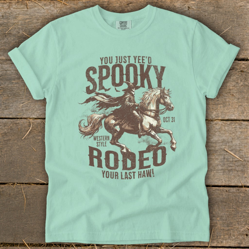 T-shirt with "Spooky Rodeo" graphic featuring a witch on horseback.
